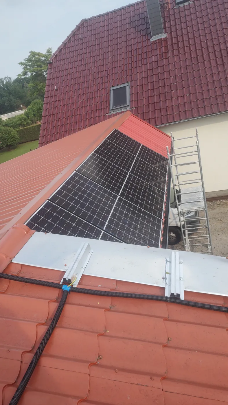 Moduły PV na dachu i przewody poprowadzone w rurze osłonowej